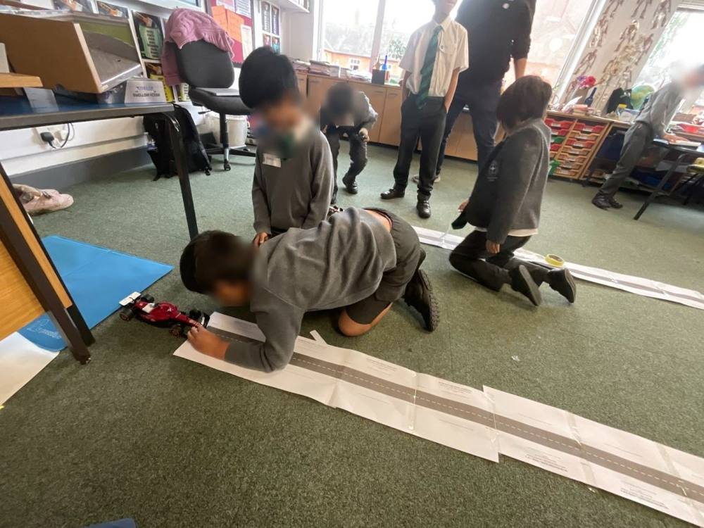 Pupils testing a car on a paper track